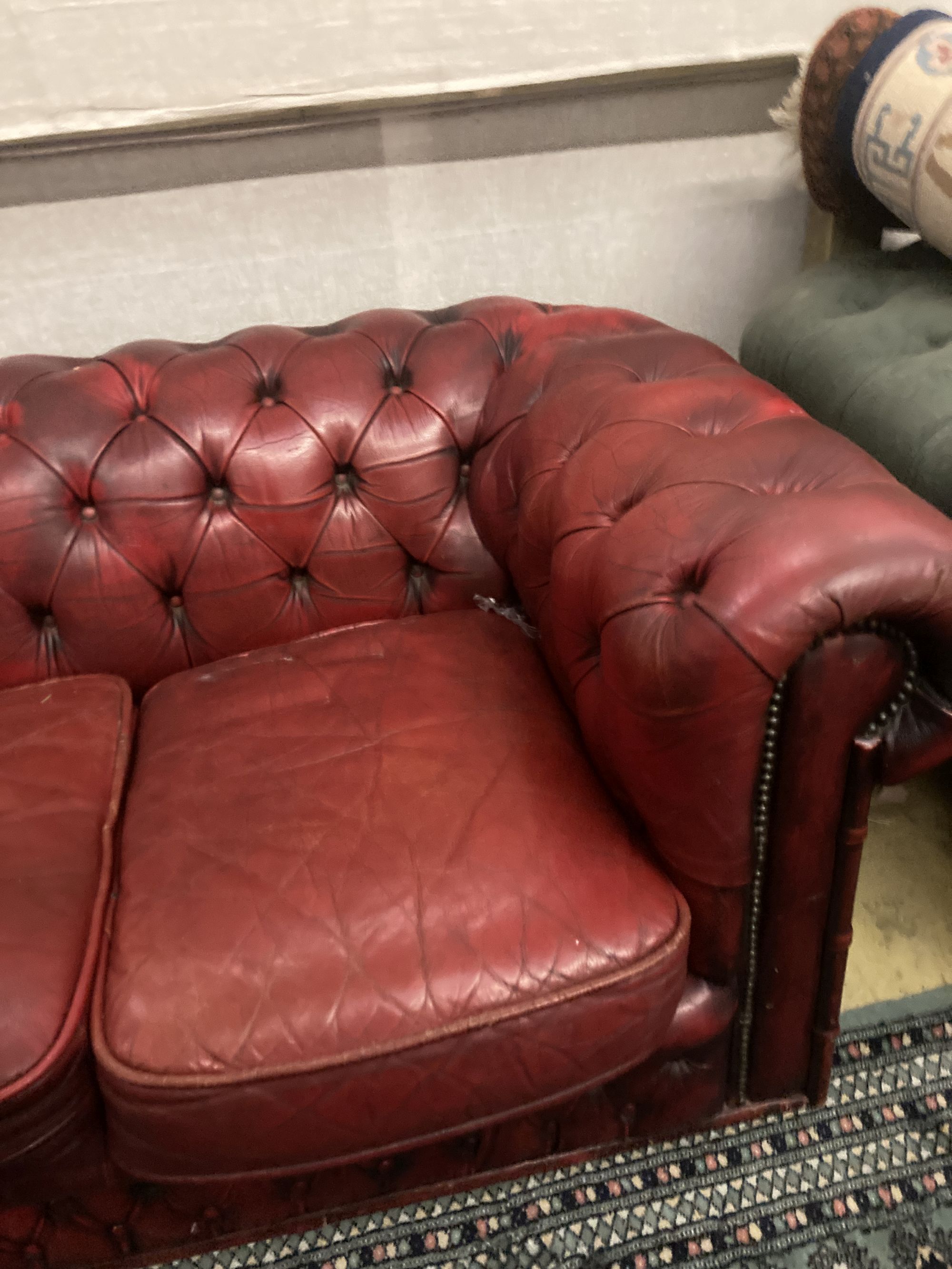 A Victorian style buttoned red leather Chesterfield settee, width 186cm depth 84cm height 66cm